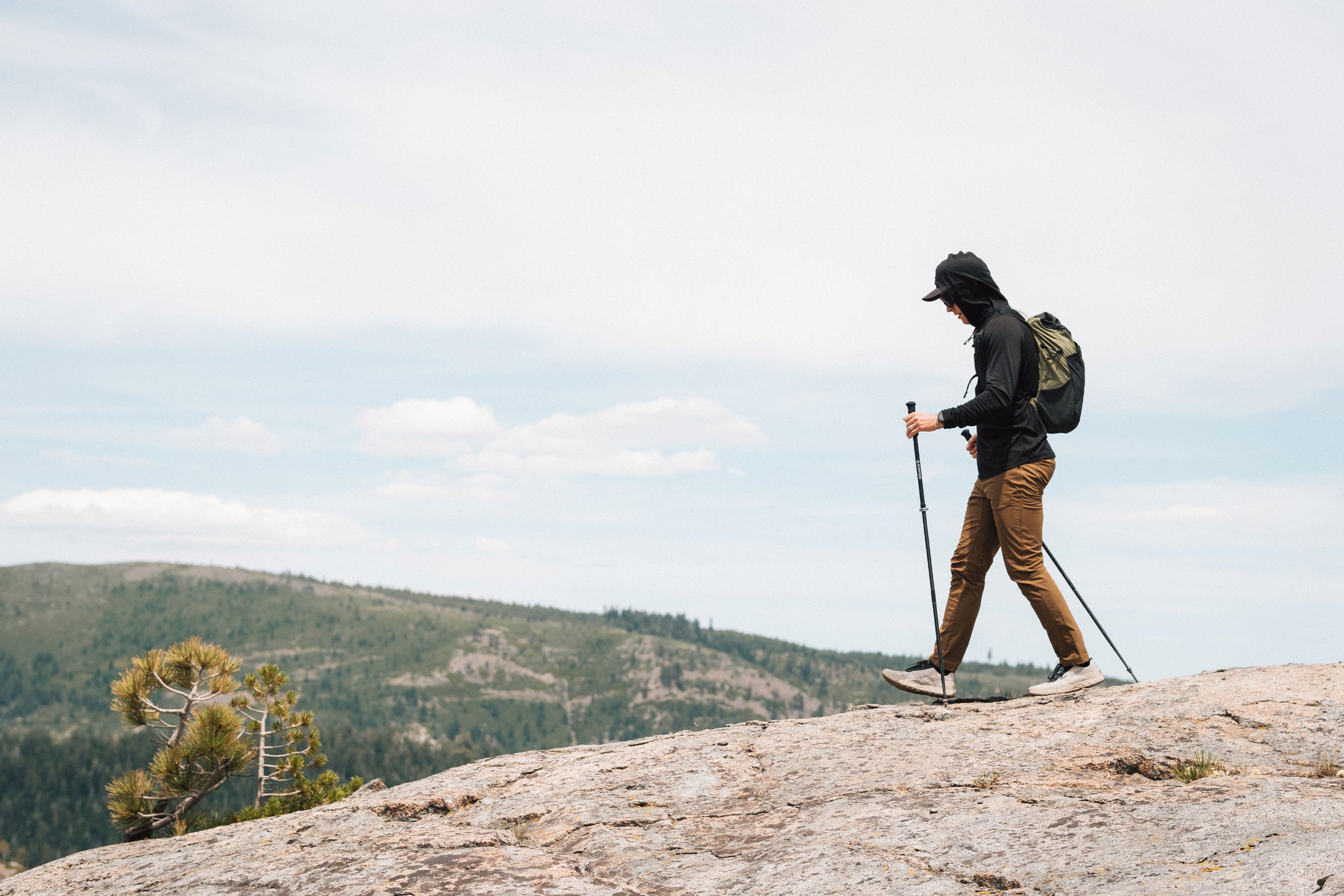 Man hiking wearing brown stretchy, durable KETL Shenanigan Outdoor pants.