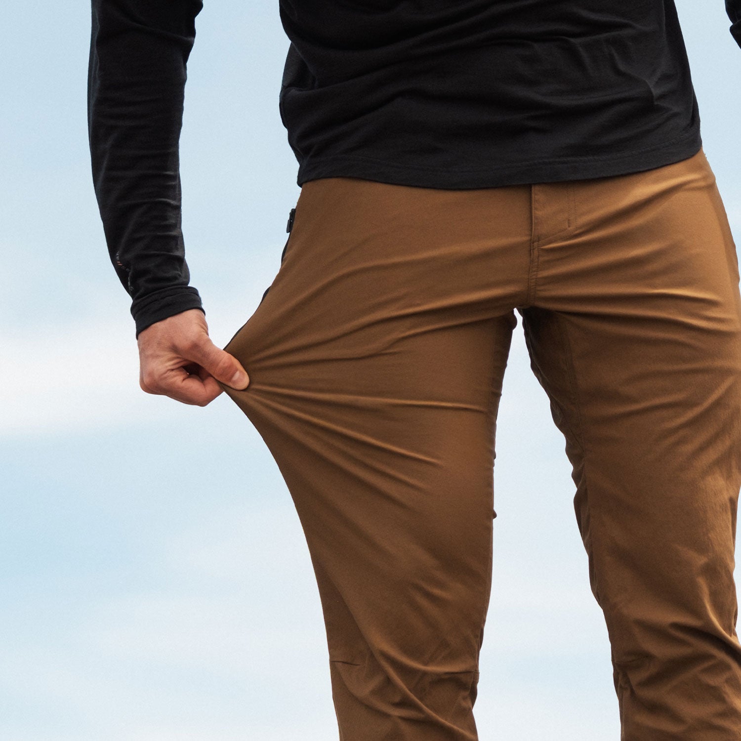 Man displaying how stretchy the KETL Shenanigan Outdoor pants are.