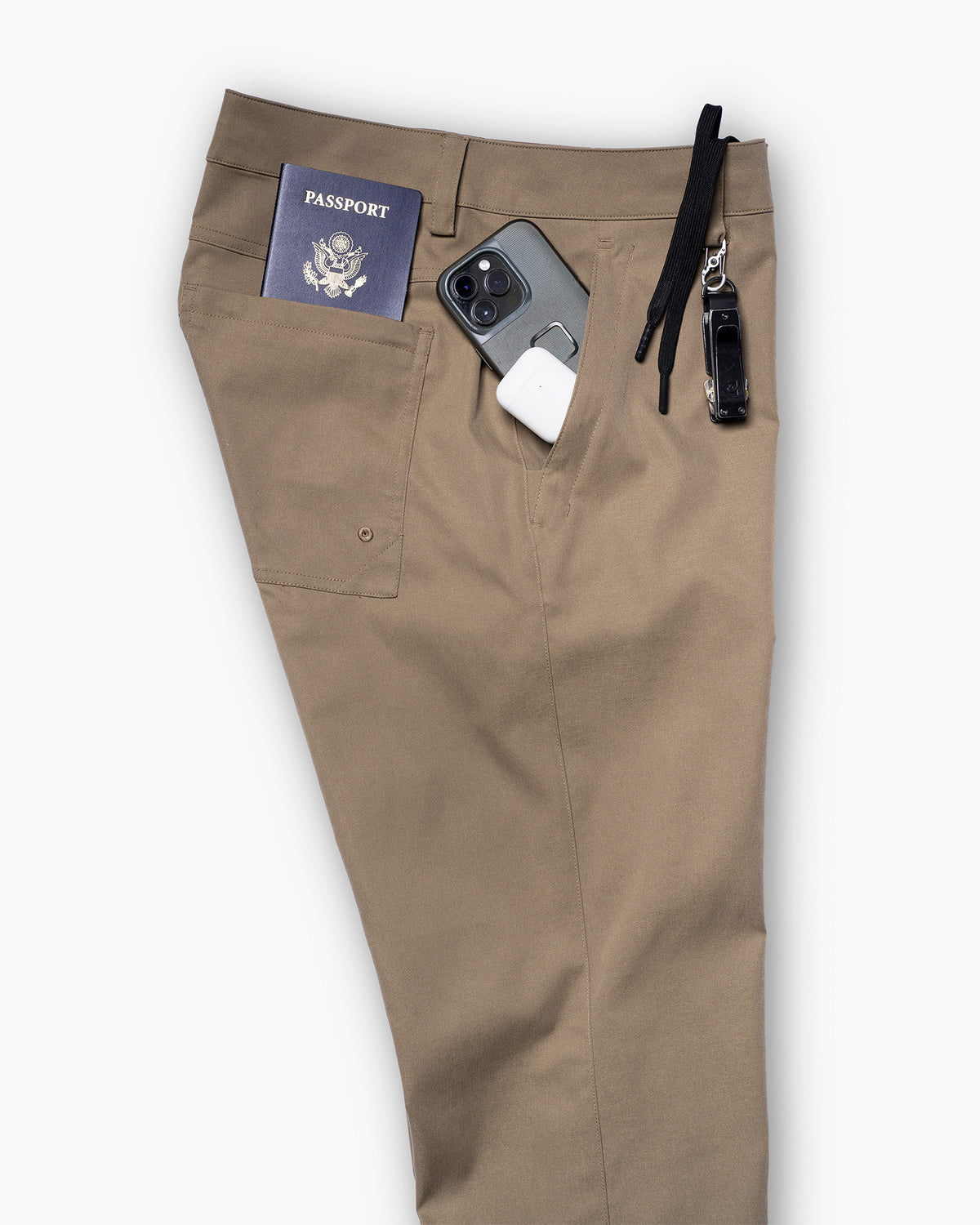 Model wearing Ketl Mountain Apparel Tomfoolery Chino Travel Pants Straight Fit in khaki, standing outdoors showing full fit and style